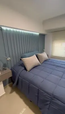 a large blue bed with a blue headboard in a room at Dpto Obispo Trejo - Nueva Cba - Alquiler mínimo por 3 meses in Cordoba