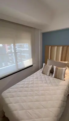a bedroom with a large white bed with a window at Dpto Obispo Trejo - Nueva Cba - Alquiler mínimo por 3 meses in Cordoba