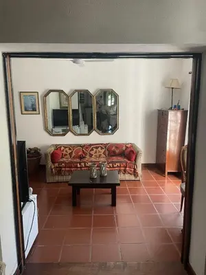a living room with a couch and a table at Cabañas el Bierzo in Villa Cura Brochero