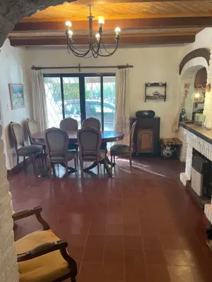 a dining room with a table and chairs at Cabañas el Bierzo in Villa Cura Brochero
