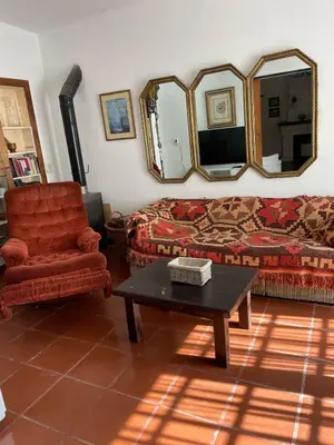 a living room with a couch and a chair at Cabañas el Bierzo in Villa Cura Brochero