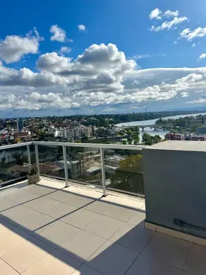a balcony with a view of a river and a city at Depto 