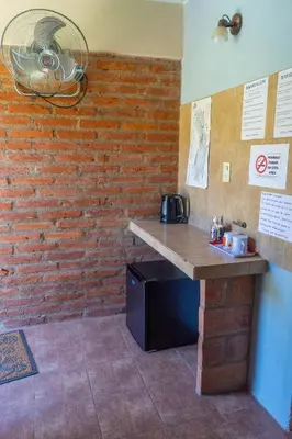 a kitchen with a counter and a brick wall at Posada Tinktinkie in Santa Rosa de Calamuchita