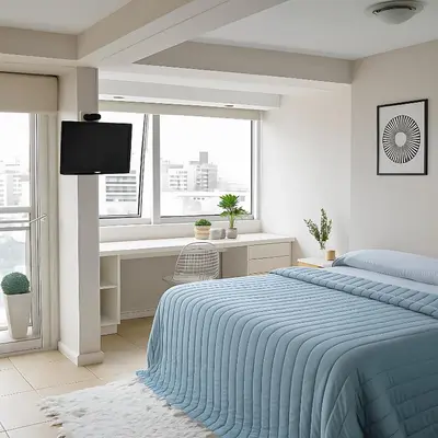 a bedroom with a bed and a desk and window at Coral State Premium Tower in Cordoba
