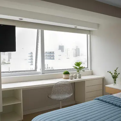 a bedroom with a bed and a desk and a window at Coral State Premium Tower in Cordoba
