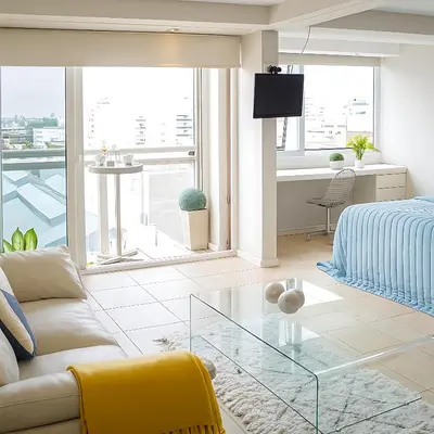 a living room with a couch and a glass table at Coral State Premium Tower in Cordoba