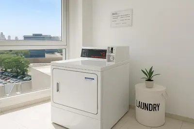 a kitchen with a small refrigerator and a window at Coral State Premium Tower in Cordoba