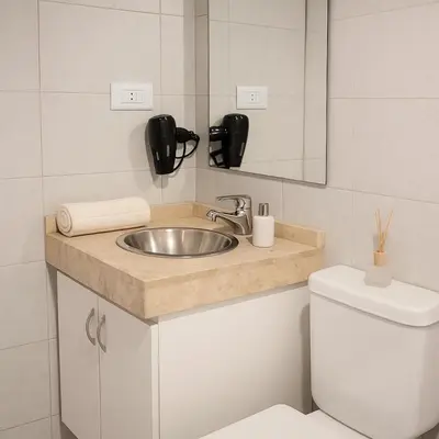 a bathroom with a sink and a toilet at Coral State Premium Tower in Cordoba