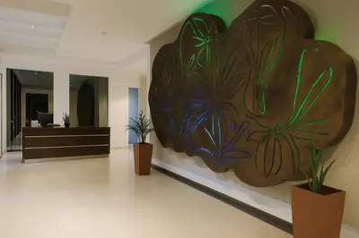 a large wooden art on the wall of a lobby at Coral State Premium Tower in Cordoba