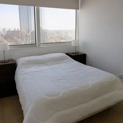a white bed in a room with two windows at Coral State Premium Tower in Cordoba