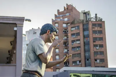 a statue of a man looking at his cell phone at Depto. 2 Dorm. premium vista Buen Pastor Av Yrigoyen in Cordoba