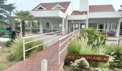 a house with a sign in front of it at HOTEL CRISTAL in Villa Carlos Paz