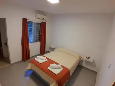 a small bedroom with a bed and a window at HOTEL CRISTAL in Villa Carlos Paz
