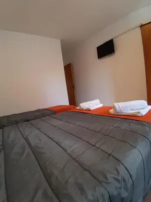 a bedroom with a large bed with two pillows on it at HOTEL CRISTAL in Villa Carlos Paz
