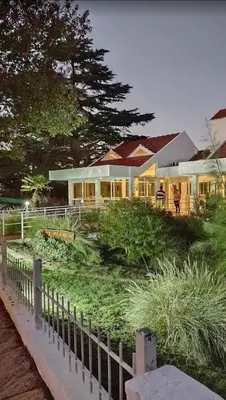 a house with a fence in front of it at HOTEL CRISTAL in Villa Carlos Paz
