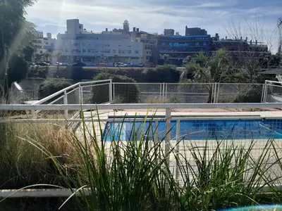 a swimming pool with a city in the background at HOTEL CRISTAL in Villa Carlos Paz