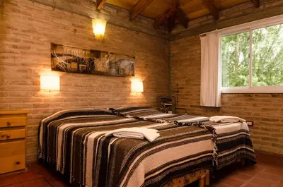 a bedroom with a large bed in a room at La Argentina Complejo in Villa Ciudad de America