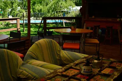 a person sitting on a couch in a living room at La Argentina Complejo in Villa Ciudad de America