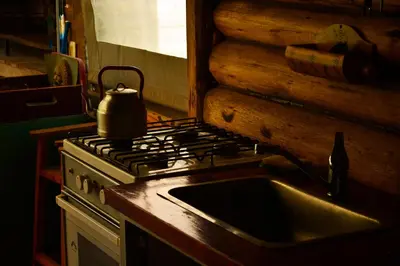 a kitchen with a sink and a tea kettle on a stove at La Argentina Complejo in Villa Ciudad de America