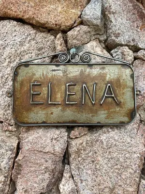 a sign that says elena sitting on some rocks at Pueblo Santo, Cabañas & Suites in San Javier