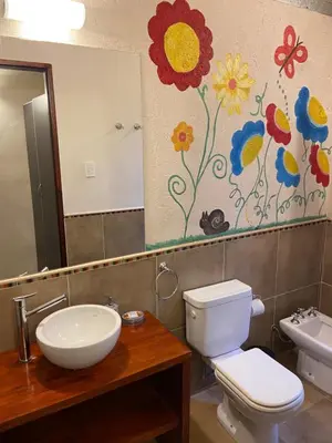 a bathroom with a sink and a toilet and a mirror at Pueblo Santo, Cabañas & Suites in San Javier