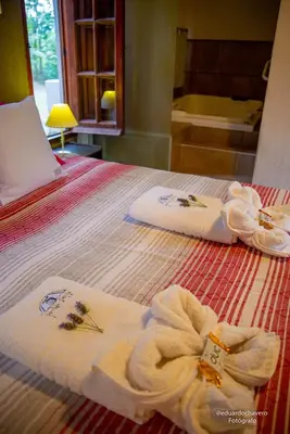 a hotel room with towels on a bed at Pueblo Santo, Cabañas & Suites in San Javier