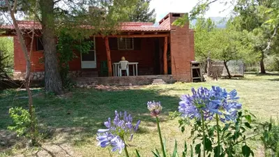 a house with purple flowers in front of it at Al pie del cerro in San Javier