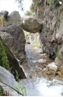 a stream of water on the side of a mountain at Al pie del cerro in San Javier