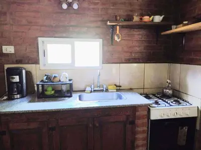 a kitchen with a sink and a stove at Al pie del cerro in San Javier