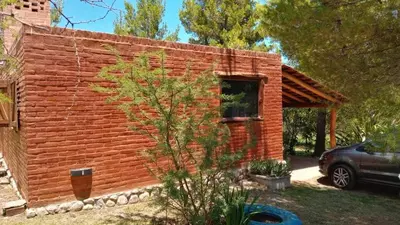 a brick house with a car parked in front of it at Al pie del cerro in San Javier