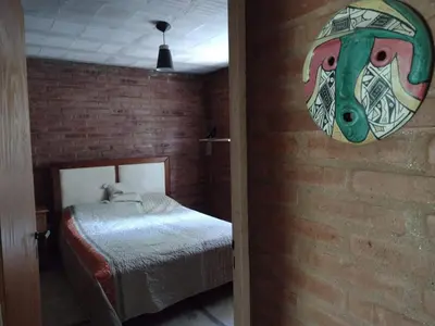 a room with a bed and a brick wall at Al pie del cerro in San Javier