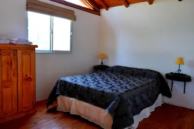 a bedroom with a bed and a window at Rancho Pampa in Villa Ciudad Parque