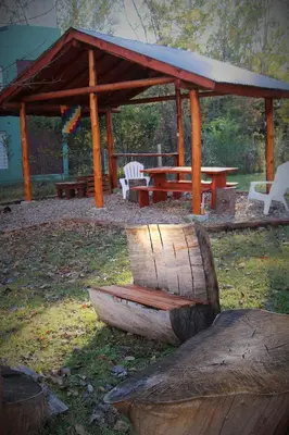 a picnic shelter with a wooden bench and a picnic table at Rancho Pampa in Villa Ciudad Parque