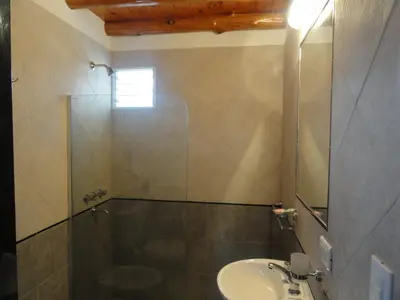 a bathroom with a shower and a sink at Rancho Pampa in Villa Ciudad Parque
