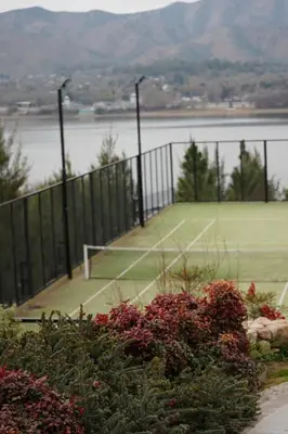 a tennis court with two tennis rackets on it at Veneto Village - Vista al Lago - 10 minutos a Carlos Paz in Villa Parque Siquiman