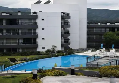 a swimming pool in front of a building at Veneto Village - Vista al Lago - 10 minutos a Carlos Paz in Villa Parque Siquiman