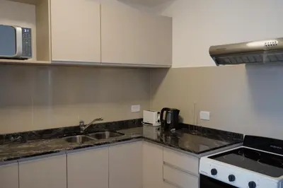 a kitchen with a sink and a counter top at Veneto Village - Vista al Lago - 10 minutos a Carlos Paz in Villa Parque Siquiman