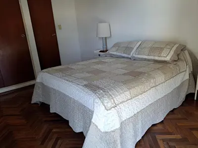 a bedroom with a bed with a blanket on it at Espacio C Av Poeta Lugones GRAN VISTA in Cordoba