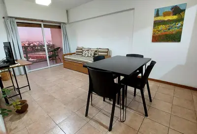 a dining room with a table and chairs and a couch at Espacio C Av Poeta Lugones GRAN VISTA in Cordoba