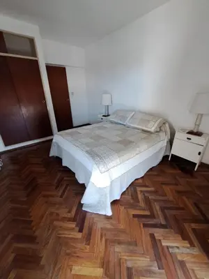 a bedroom with a bed and a wooden floor at Espacio C Av Poeta Lugones GRAN VISTA in Cordoba