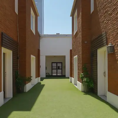 an empty hallway between two red brick buildings at Atenea Residence in Cordoba