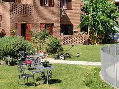 a patio with a table and chairs in a yard at Depto del Lago in Villa Carlos Paz