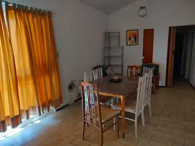 a dining room with a wooden table and chairs at Depto del Lago in Villa Carlos Paz