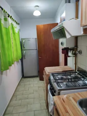 a kitchen with a stove and a refrigerator at Depto del Lago in Villa Carlos Paz
