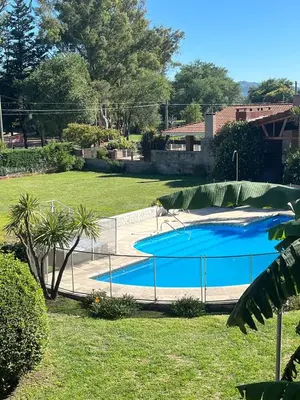 a large swimming pool with a fence around it at Depto del Lago in Villa Carlos Paz
