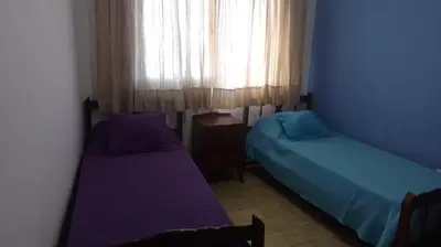 a bedroom with two beds and a window at Depto del Lago in Villa Carlos Paz