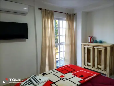 a bedroom with a bed and a window at Departamentos Los Almendros in Merlo