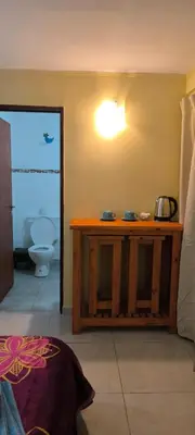 a bathroom with a wooden table and a toilet at Departamentos Los Almendros in Merlo