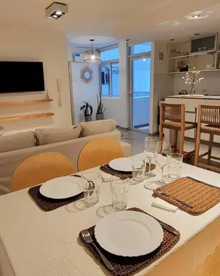 a table with plates and glasses on it in a living room at La mejor ubicación para alojarte! in Cordoba