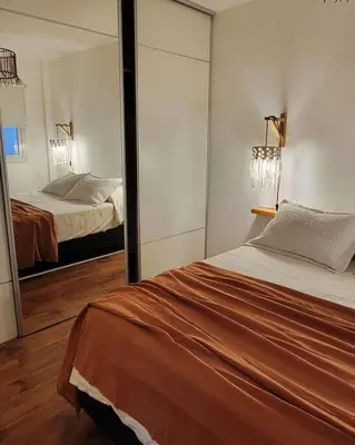 a bedroom with a bed and a large mirror at La mejor ubicación para alojarte! in Cordoba